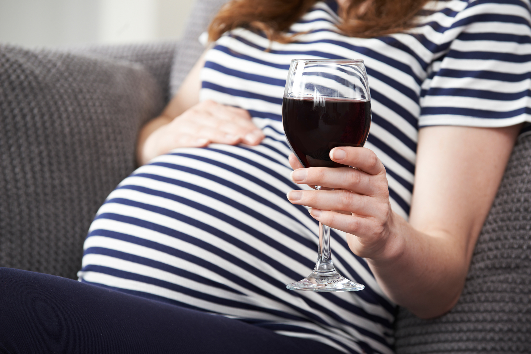 Close Up Of Pregnant Woman Drinking Red Wine by HighwayStarz.
